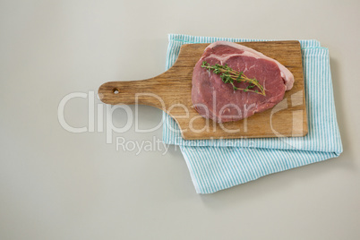 Sirloin chop on wooden tray with cooking cloth