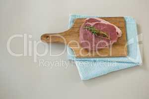Sirloin chop on wooden tray with cooking cloth
