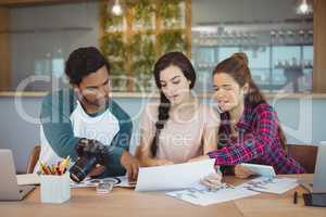 Graphic designers sitting at table and interacting