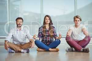 Business executives practicing yoga