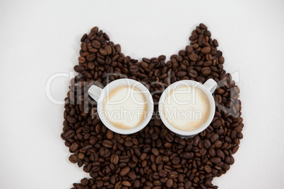 Coffee beans and cups forming owl