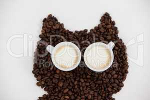 Coffee beans and cups forming owl