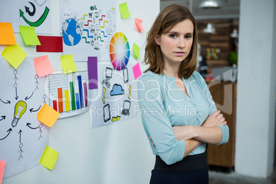 Female graphic designer standing with hands crossed