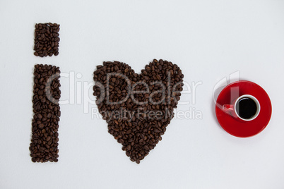 Coffee beans and cups forming I love, addiction coffee