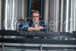 Male factory worker sitting at drinks production factory