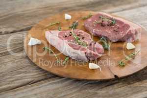 Sirloin steak, garlic and herb on wooden tray against wooden background