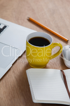 Cup of coffee with laptop, organizer, pencil and mouse