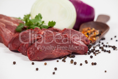 Beef steak and spices against white background