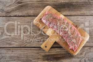 Beef ribs on wooden tray against wooden background