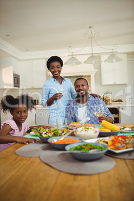 Portrait of family having meal on dinning table at home