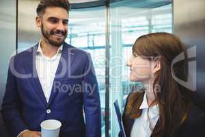 Business executives interacting in lift