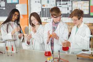 Attentive school kids doing a chemical experiment in laboratory