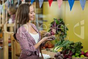 Woman choosing vegetables in grocery store