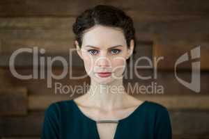 Confident female business executive standing in office