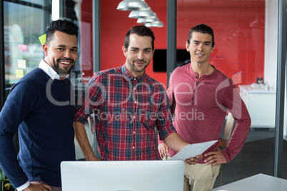Business executives standing with document in office