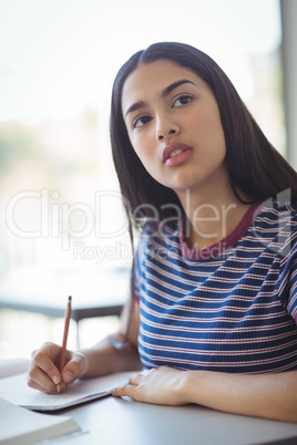 Schoolgirl doing his homework in classroom