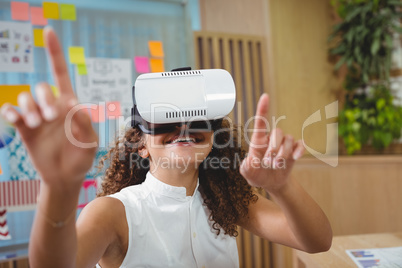 Female business executive using virtual reality headset