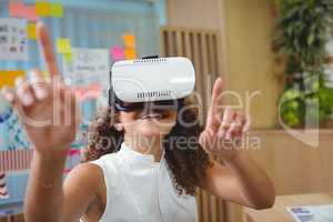 Female business executive using virtual reality headset
