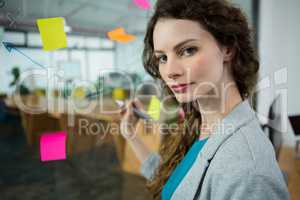 Female executive writing on sticky notes