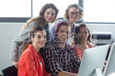 Smiling business executives working in office