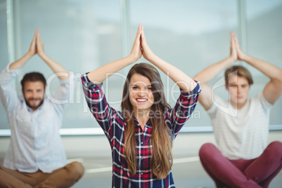 Business executives practicing yoga