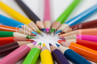 Close-up of colored pencils arranged in a circle