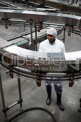 Factory engineer monitoring a production line