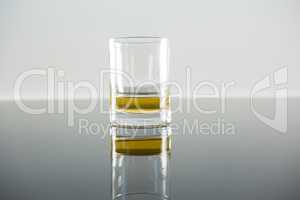 Glass of whisky on table