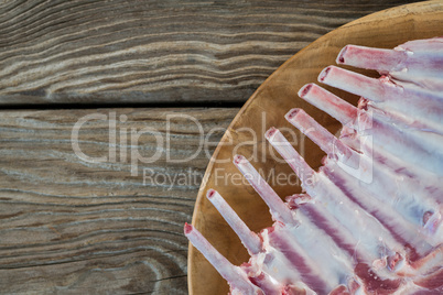 Beef ribs rack on wooden tray against wooden background