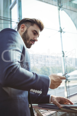 Attentive businessman using mobile phone