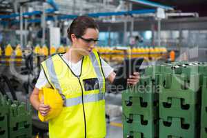 Female factory worker using a digital tablet in factory