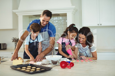 Happy family preparing cookies in kitchen