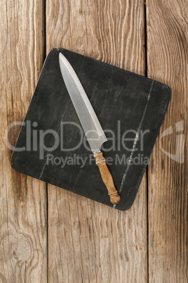 Knife on black slate plate