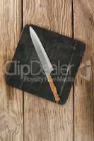Knife on black slate plate