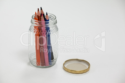 Colored pencils kept in a glass jar