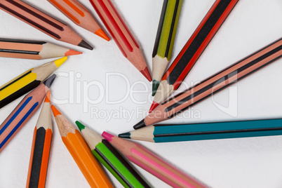 Close-up of colored pencils arranged in a circle