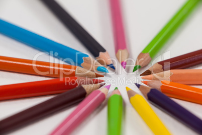 Close-up of colored pencils arranged in a circle