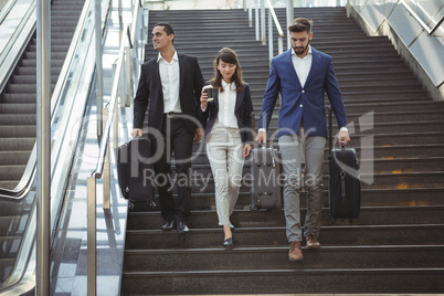 Businesses executives walking on stairs outside platform