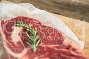 Sirloin chop and rosemary herb on wooden tray