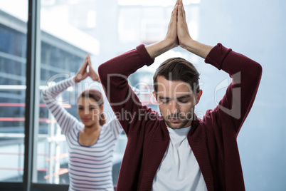 Man and woman doing yoga