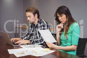 Male and graphic designers working together in conference room