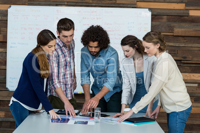 Business team discussing over digital tablet in meeting