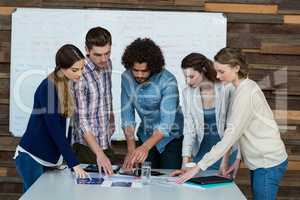 Business team discussing over digital tablet in meeting