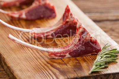 Rib chops and rosemary herb on wooden tray