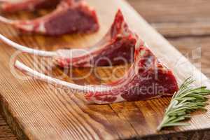 Rib chops and rosemary herb on wooden tray