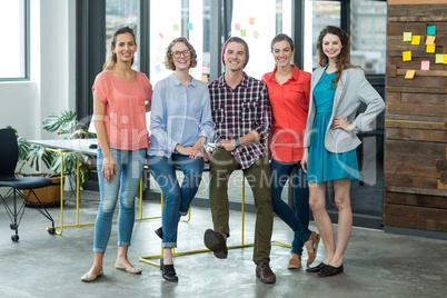Smiling business executives standing in office Smiling business executives standing in office