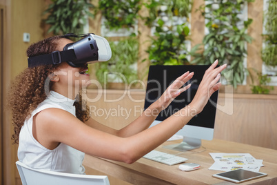 Female business executive using virtual reality headset