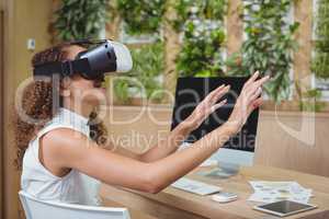 Female business executive using virtual reality headset