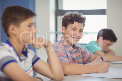 Students sitting at desk in classroom