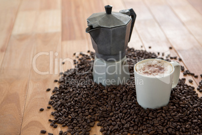 Coffeemaker with coffee beans and coffee mug